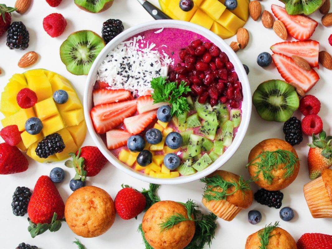 assorted sliced fruits in white ceramic bowl