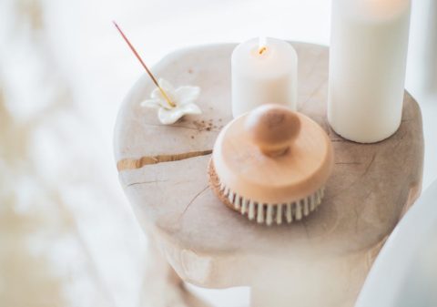 incense and white candles on a stool